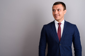 Businessman wearing suit against gray background