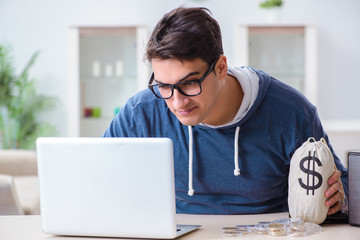 Young man mining bitcoins at home