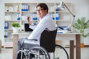 Disabled doctor on wheelchair working in hospital