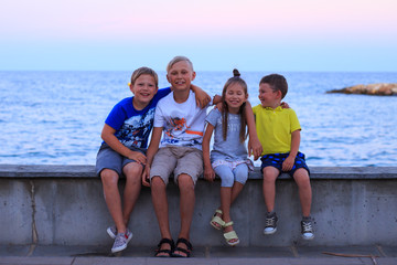 Four children on beach vocation. Young family on vacation have a lot of fun.