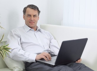 businessman with laptop works in the room