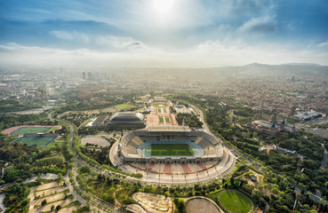 Fototapeta premium Barcelona aerial panorama, Anella Olimpica sport complex on the hill with city skyline , Spain. Sunbeam light