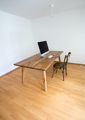 minimalistic office with table and chair and computer