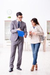 Real estate agent showing new apartment property to client