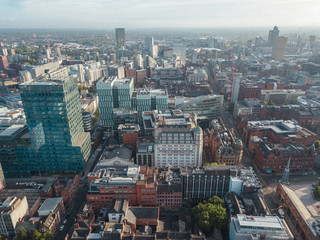 Naklejka premium Manchester City Centre Drone Aerial View Above Building Work Skyline Construction Blue Sky Summer Beetham Tower Deansgate.