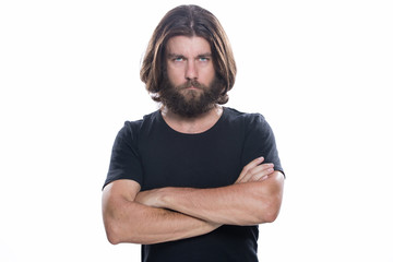 Fototapeta premium Portrait of handsome confident man with beard in standing with crossed arms isolated on white