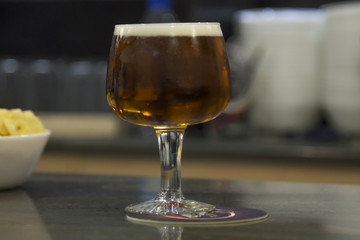 beer glass and bowl of chips