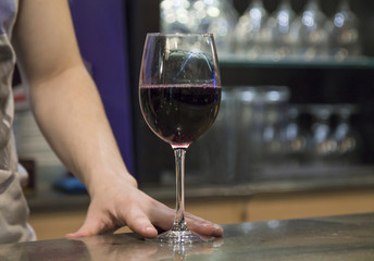 waiter with glass of wine in the pub
