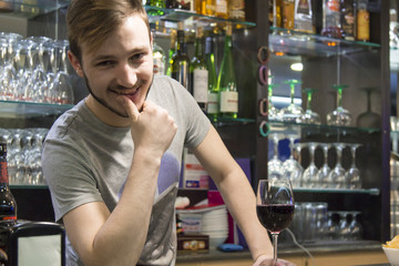 waiter with glass of wine in the pub