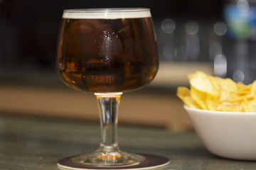 beer glass and bowl of chips