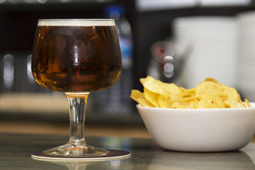 beer glass and bowl of chips