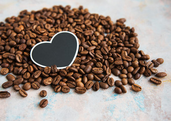 Coffee beans and card in the shape of a heart