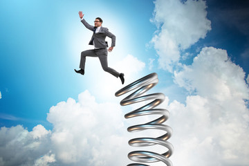 Businessman jumping from spring in promotion concept