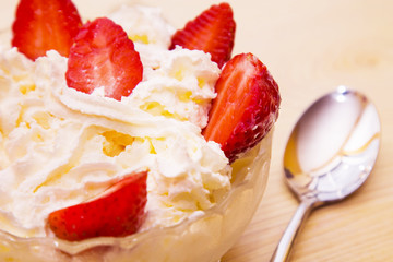 glass bowl of strawberries with cream