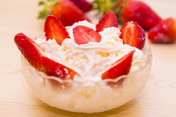 glass bowl of strawberries with cream