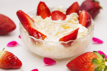 glass bowl of strawberries with cream