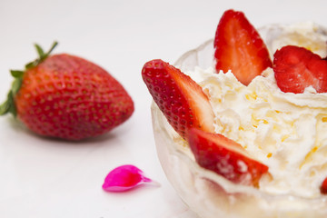 glass bowl of strawberries with cream