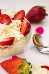 glass bowl of strawberries with cream