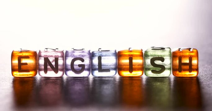 Close up light moving on english alphabet cube block which arrangement as ENGLISH word , English study concept