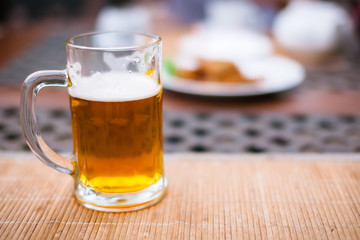 beer cup with light beer on the table in the outdoor restaurant