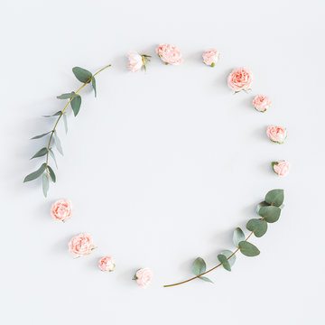 Flowers composition. Wreath made of rose flowers, eucalyptus branches on pastel gray background. Flat lay, top view, copy space, square