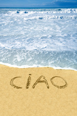 Fototapeta na wymiar Ciao written on the beach