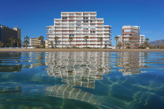 Beach with buildings seen from water surface, Spain, Costa Brava, Mediterranean sea, Santa Margarida, Roses, Catalonia, Girona