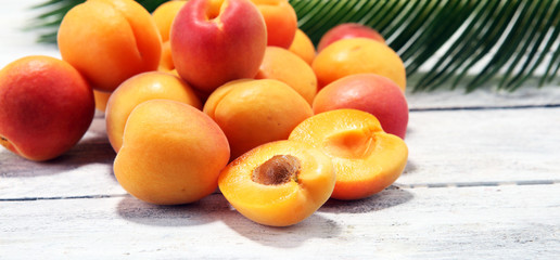 Bunch of fresh apricots on wooden table.
