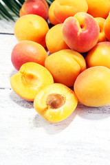 Bunch of fresh apricots on wooden table.
