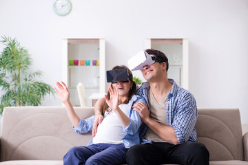 Young couple trying virtual reality glasses goggles