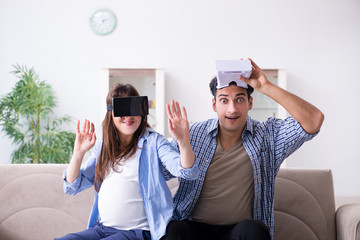 Young couple trying virtual reality glasses goggles