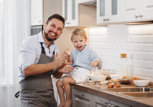 happy family in kitchen. father and child baking cookies