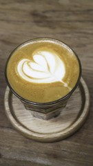 Cup of piccolo latte coffee with latte art