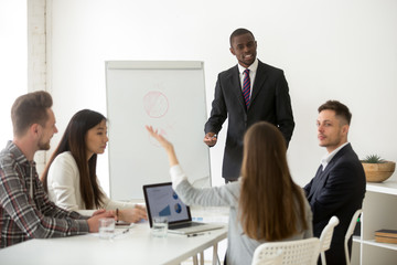 African american business coach speaker answering questions at corporate office training, black manager discussing presentation listening to sales team member asking or disagreeing about new project