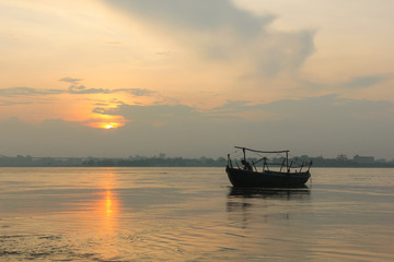 A boat at sunrise by Ganges river in Varanasi, India. Travel destination concept