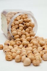 Shelled and peeled hazelnuts on a white background