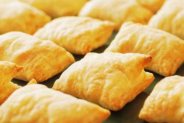 Close up view of a freshly baked pies made of puff pastry with shallow depth of field