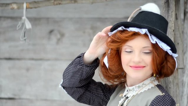 Beautiful red-haired girl posing with hand-made rat. close-up