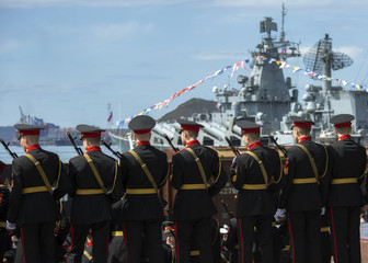 military cadets in military service against the backdrop of a military ship
