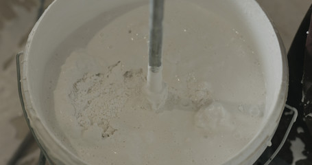 stirring putty in the bucket
