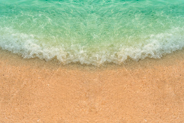 Fototapeta na wymiar top view background blue green wave on the beach.
