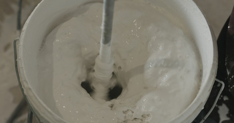 stirring putty in the bucket