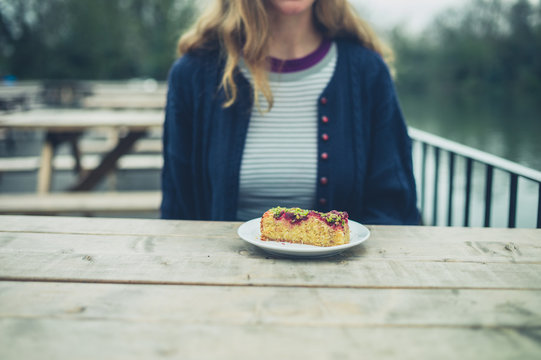 Woman eating cake outside