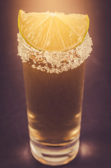 Tequila shot with lime fruit/Tequila shot with lime fruit. Cloes up and toned