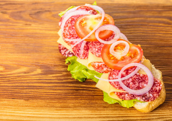 sandwich with salami, cheese and vegetables
