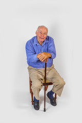 happy elderly man sitting in a chair