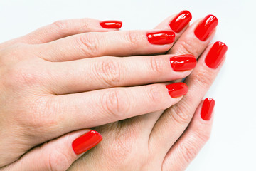 Female hands with beautiful red manicure.