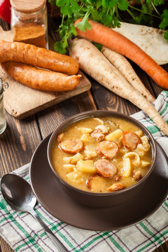 Traditional Polish split pea soup with sausage, bacon and potato