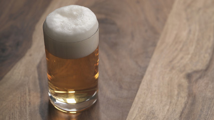 closeup ginger beer in a glass on wood table