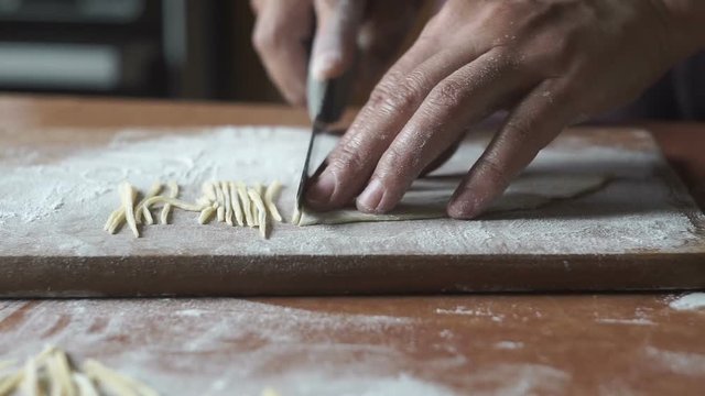 Woman hands of chef making egg homemade noodles